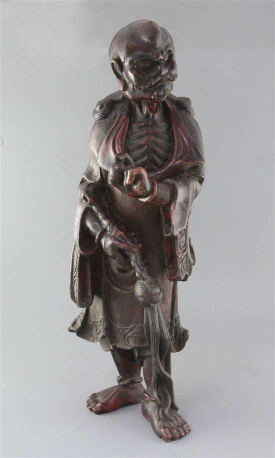 A large Chinese lacquered wood figure of a luohan, 17th/18th century h. 64cm